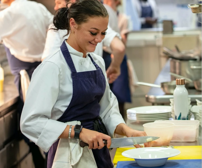 A cook chopping with a knife